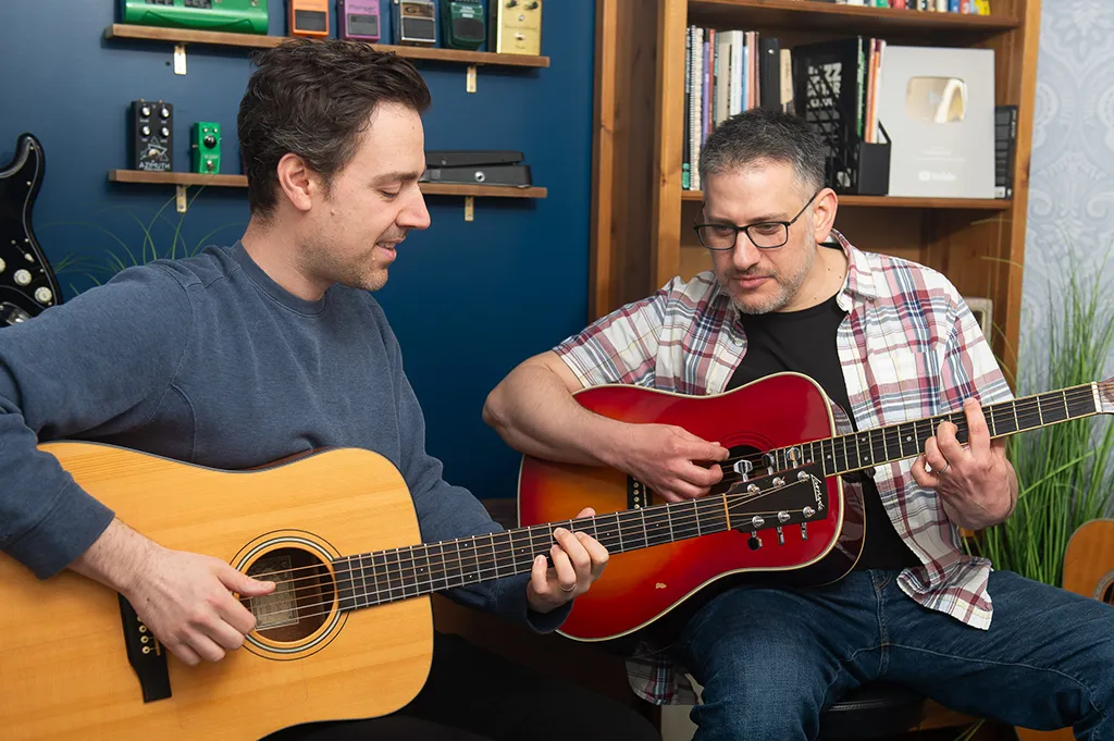 Teaching barre chords to my studente Dan